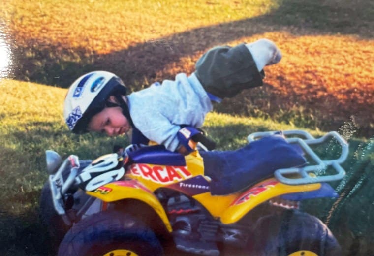 Dayton Webber, a quadruple amputee professional cornhole player, driving a quad