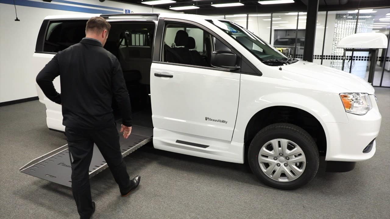 Access 2 Mobility team member demonstrating a BraunAbility wheelchair-accessible van ramp
