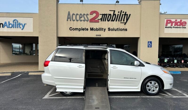 2010 Toyota Sienna XLE wheelchair van with BraunAbility power fold-out ramp deployed from the passenger side