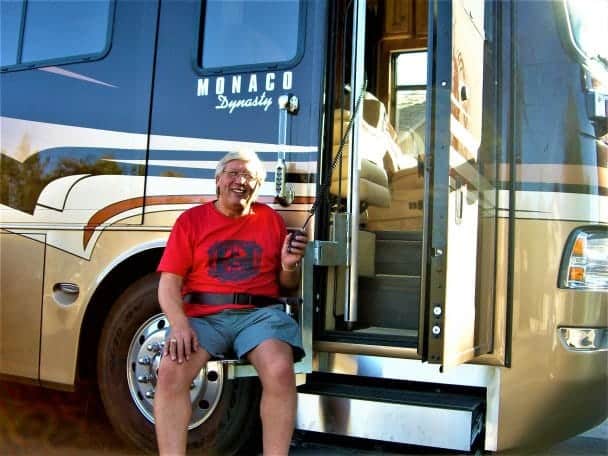 Rider seated on the lift chair holding the pendant control at a Monaco Dynasty motorhome