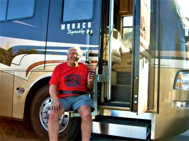 Rider seated on the lift chair holding the pendant control at a Monaco Dynasty motorhome